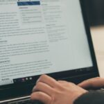 person typing on laptop computer