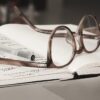 eyeglasses with gray frames on the top of notebook