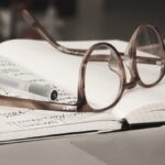 eyeglasses with gray frames on the top of notebook