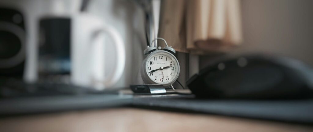 round grey alarm clock at 2:40