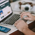 a man sitting at a desk using a laptop computer