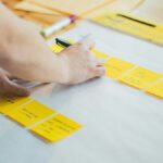 person writing on white paper