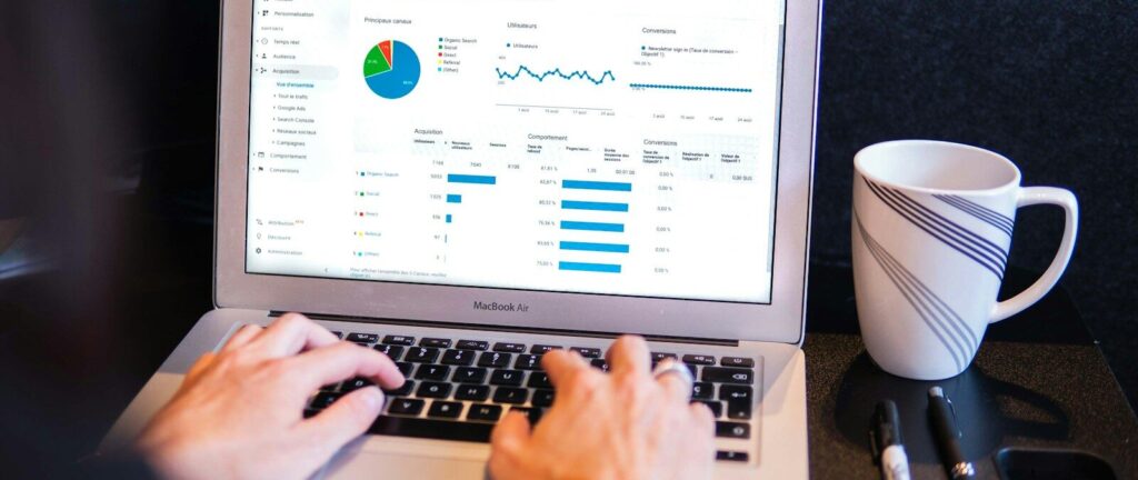 person using macbook pro on black table