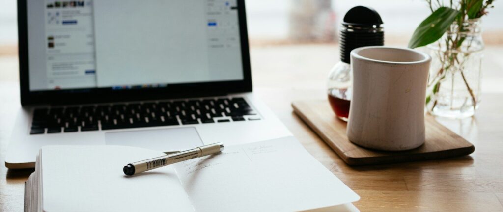 MacBook Pro near white open book