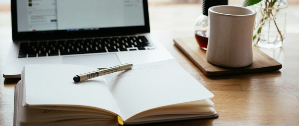 MacBook Pro near white open book