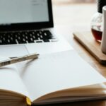 MacBook Pro near white open book