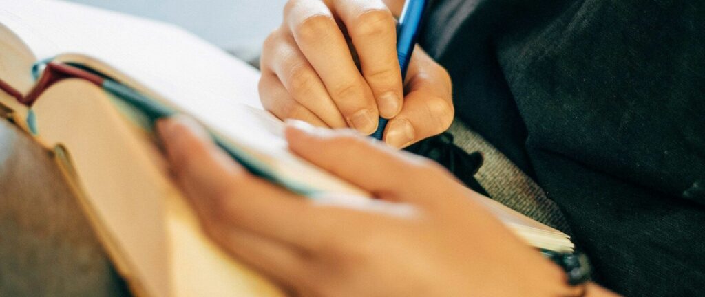 shallow focus photo of person writing