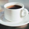 cup of coffee on white ceramic saucer
