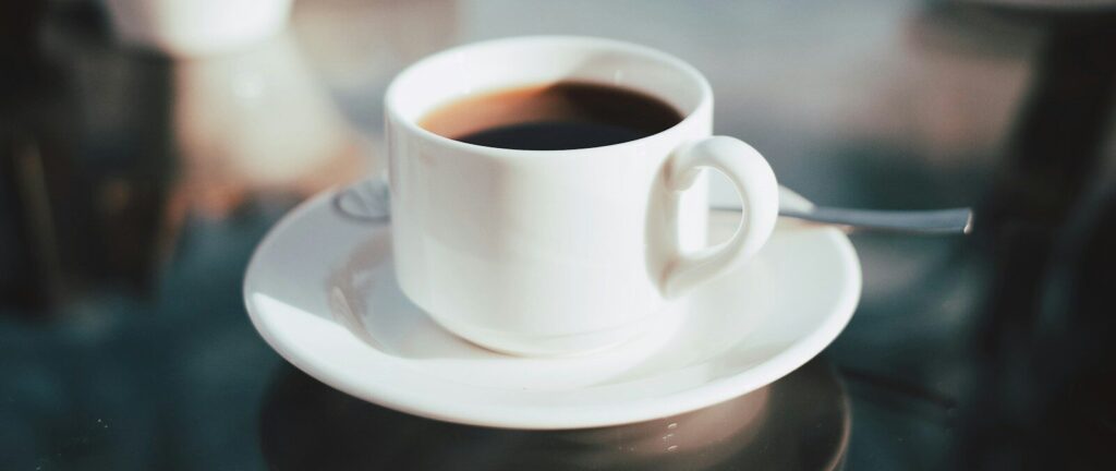 cup of coffee on white ceramic saucer