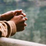 tilt-shift photography of person in brown jacket
