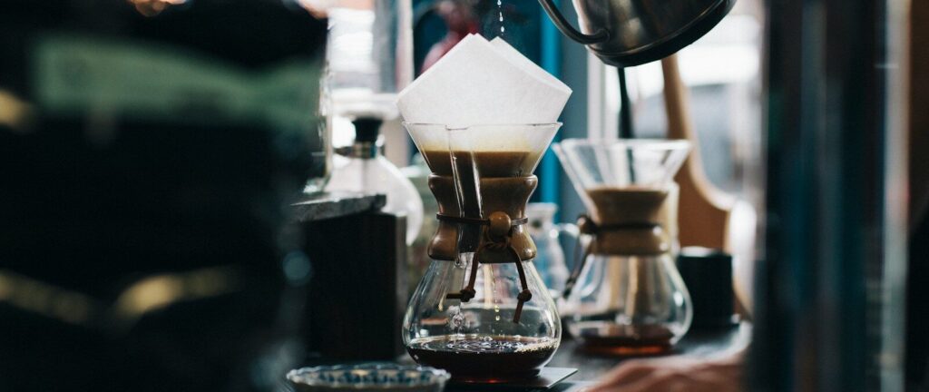 person filling glass container
