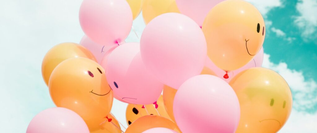 low-angle photo of pink and orange balloons
