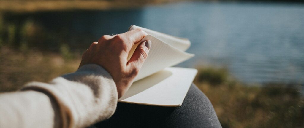 person holding white book