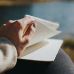 person holding white book
