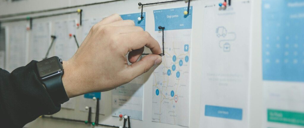 person working on blue and white paper on board