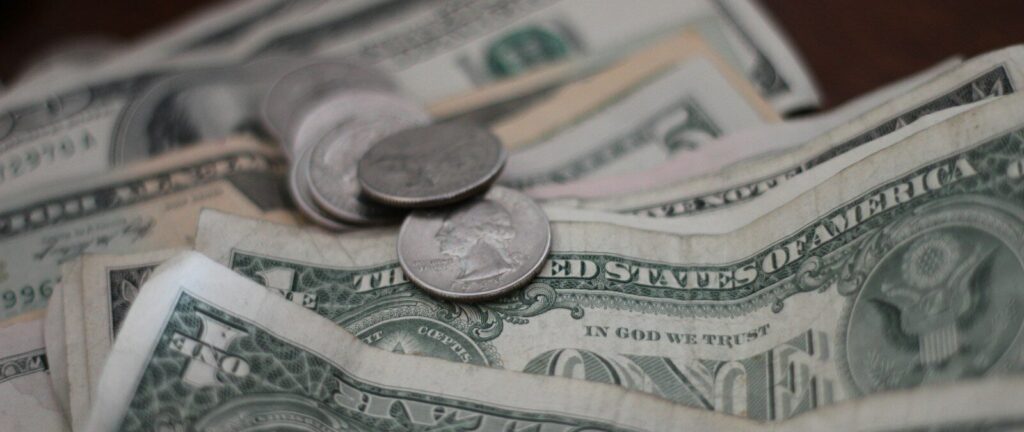 photo of dollar coins and banknotes